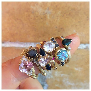 Nellie Ring with Pink Morganite and diamond side stones shown in 14K Yellow gold shown on finger with other rings.
