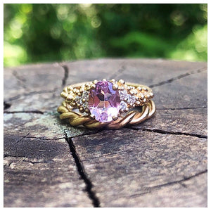 Nellie Ring with Pink Morganite and diamond side stones shown in 14K Yellow gold stacked with our twist band also in 14K yellow gold.