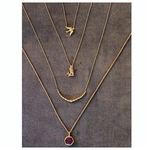 Our owl pendant shown in 14K yellow gold shown with other pieces all sold separately