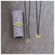 This necklace features 6 14K yellow gold buds on a rhodium plated silver chain shown with other jewelry