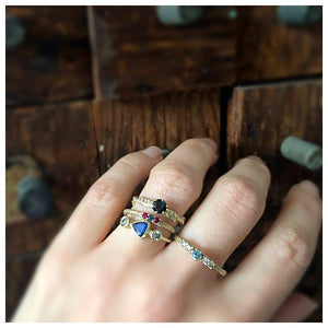 Our Scarlett ring features a gorgeous blue sapphire center stone with 2 3mm Gray diamonds on either side. on hand with other rings sold separately