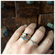 Ariana ring in 14K yellow gold  Montana Blue Sapphire and champagne diamonds shown on hand with other rings