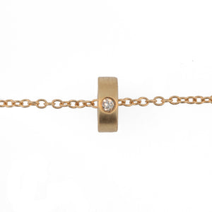 Initial ring necklace shown in 14K yellow gold with one round white diamond