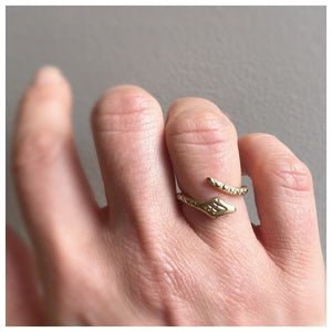 Handcarved snake ring in 14K yellow gold shown on hand