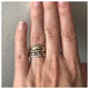 Our Stella band  features 6 sparkling  white pave diamonds in the front shown On hand with other rings