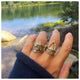 Ines ring with round opal center stone and 3 diamonds on top in 14K yellow gold shown stacked on hand