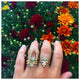 Sunrise Center ring in 14K yellow gold with round champagne diamond center stone and 11 white diamonds in arch  shown worn on hand with various rings