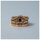 Sunrise Center ring in 14K yellow gold with round black  diamond center stone and 11 black diamonds in arch  shown stacked with other rings